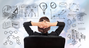 Person Looking at Business Plan While Sitting in Chair