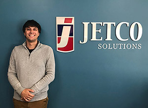 Paul Costopulos JetCo Solutions Paul Costopulos next to the JetCo Solutions sign